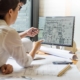 Two engineers looking at floorplans on computer